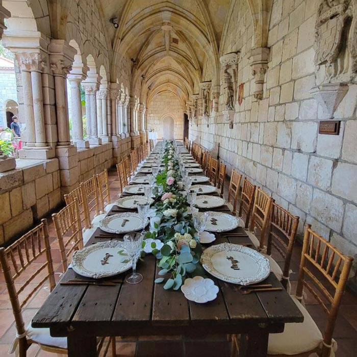 table set in long ornate hallway